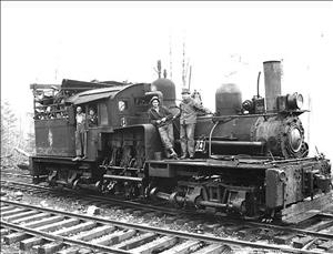 A locomotive with two man standing on it and two men leaning out of the wheelhouse. 